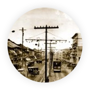 Early electric infrastructure and street traffic in Manila.