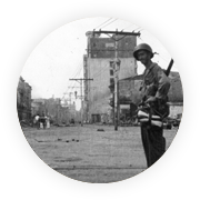 A soldier walks through war-damaged Manila after World War II.