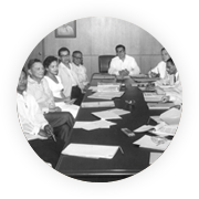 Meralco leaders and staff meet around a conference table.
