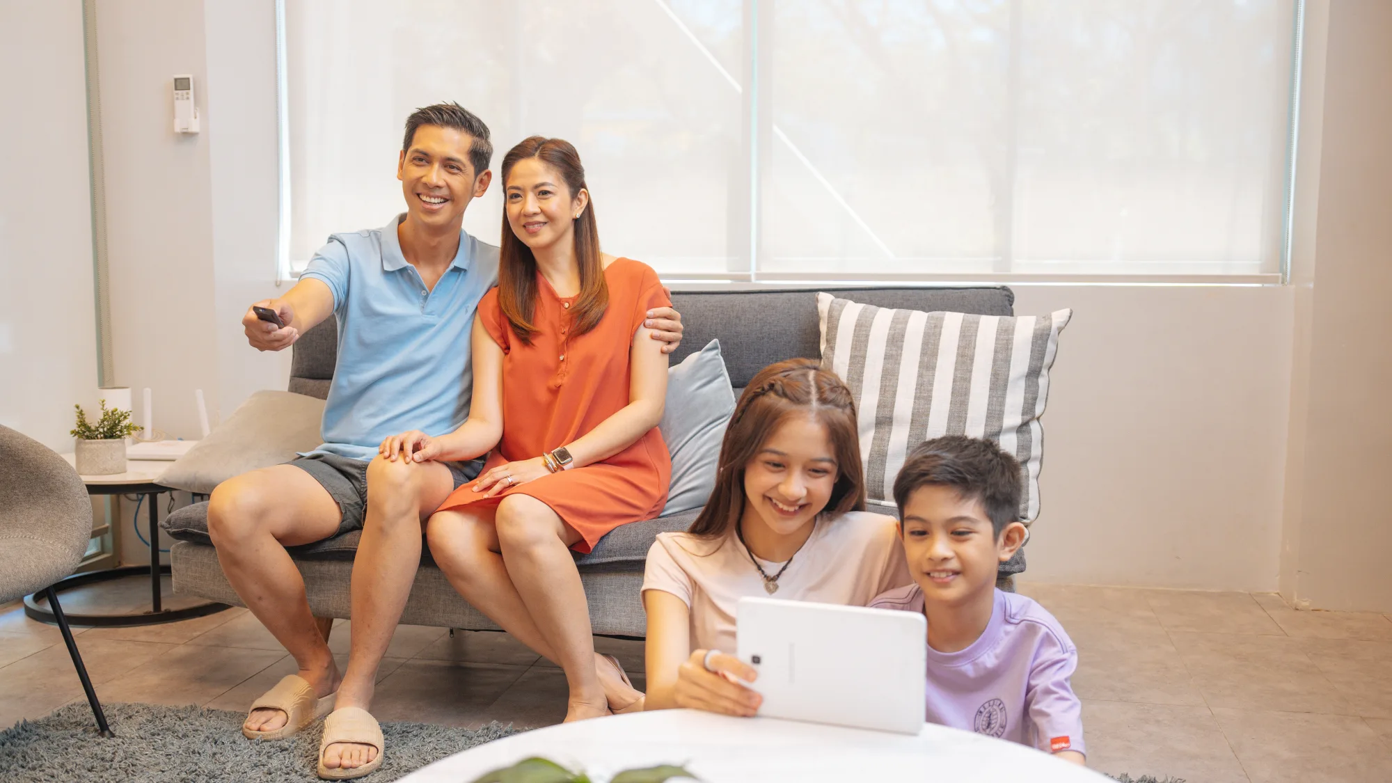 A family reviews information together in a bright living room.