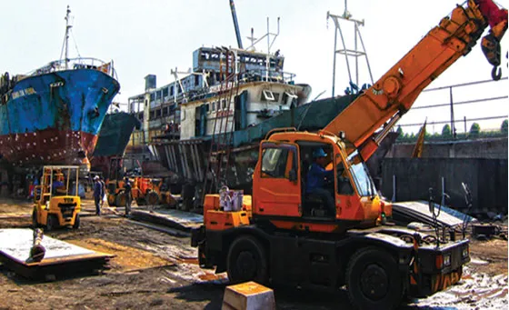 Crane and fishing vessels at the harbor.