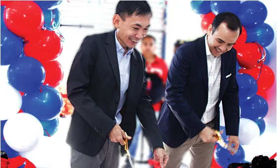 Representatives cut a ribbon at a Super 8 opening.