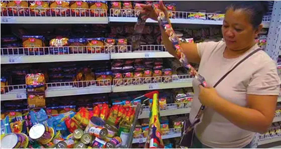 Customer shops in a Super 8 grocery aisle.