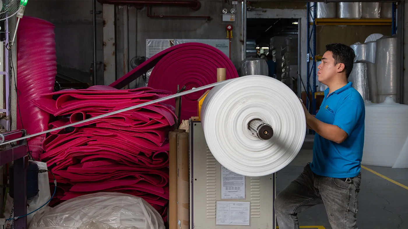 Betafoam employee operates production equipment.
