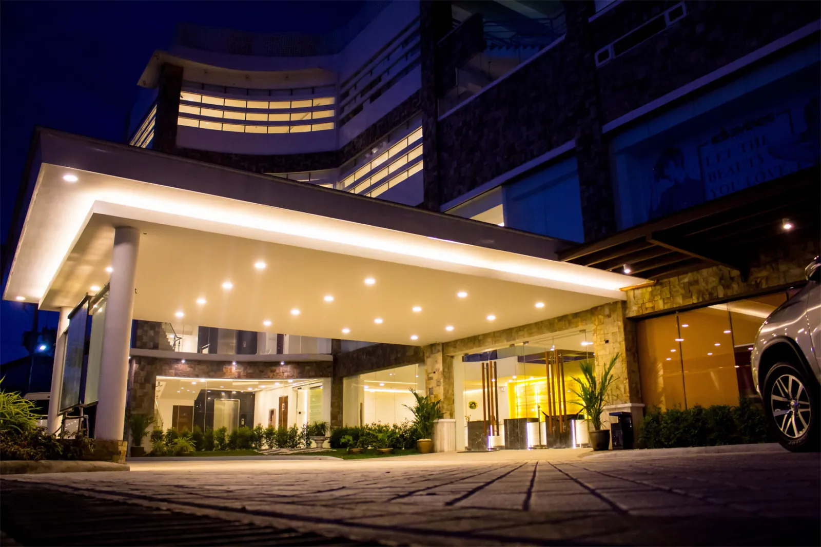 Hotel entrance illuminated at night.