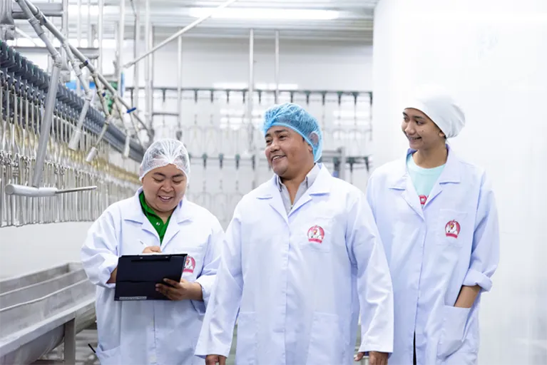 Farmrich Foods representatives at the poultry facility.