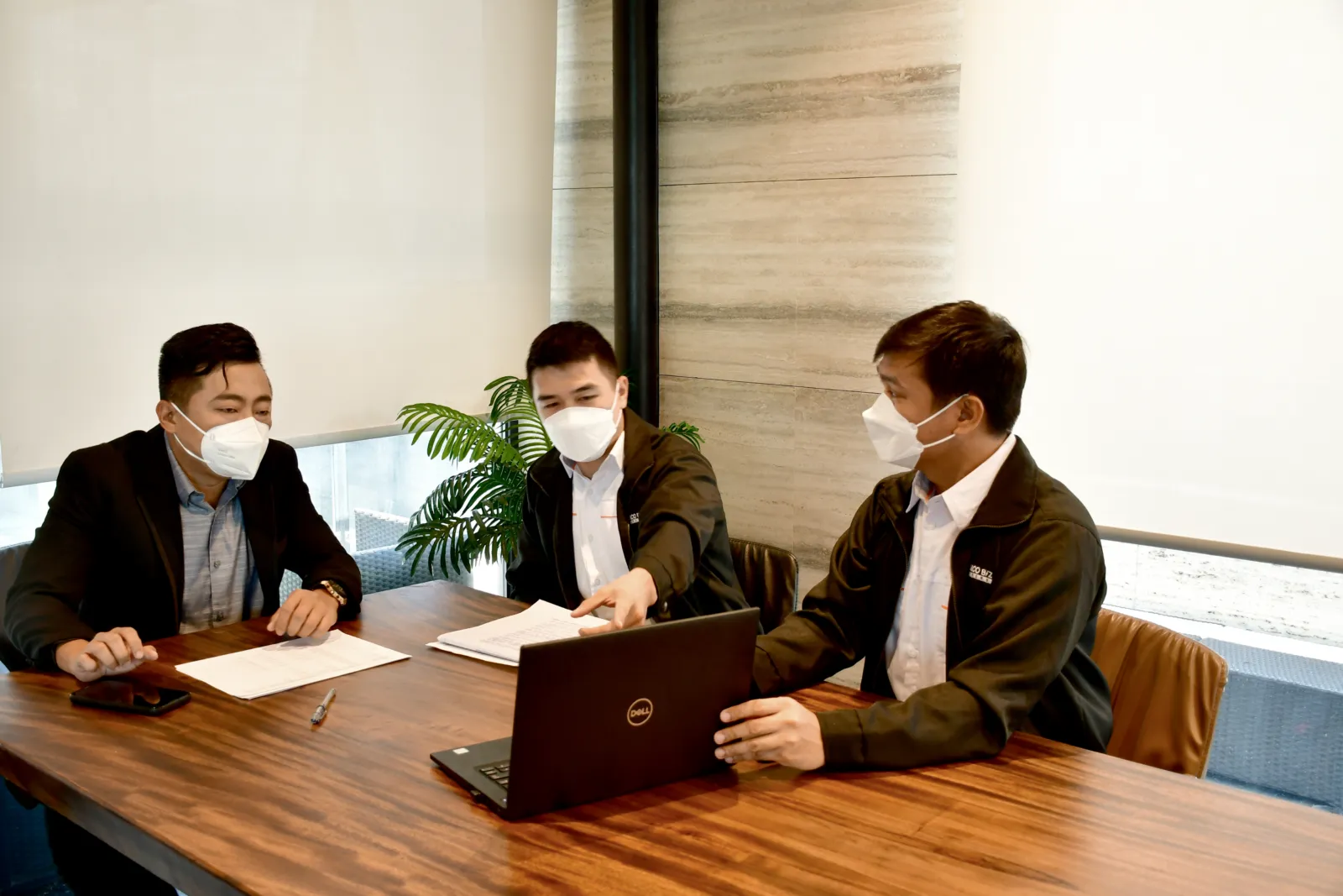SGC and Meralco representatives meet around a laptop.