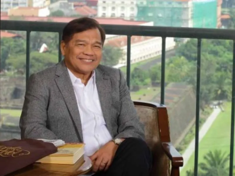 Manila Hotel representative seated beside a window.