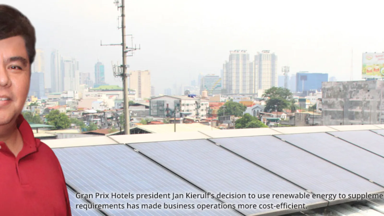 Gran Prix representative beside rooftop solar panels.
