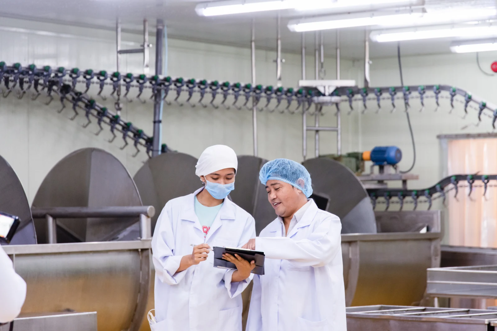 Staff reviewing operations in a food production facility.