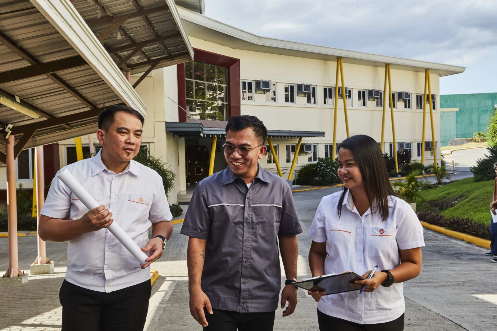 Meralco representatives discussing power requirements outside a business premises.