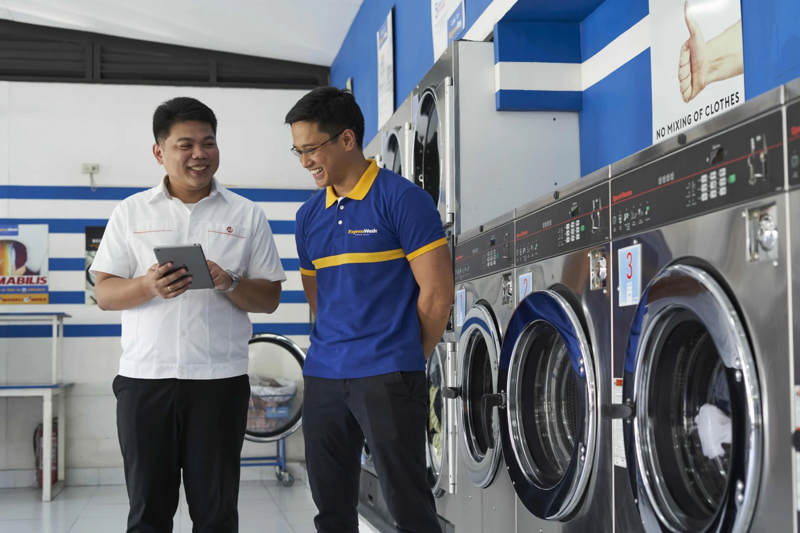 Meralco representative talking with a laundry business owner.