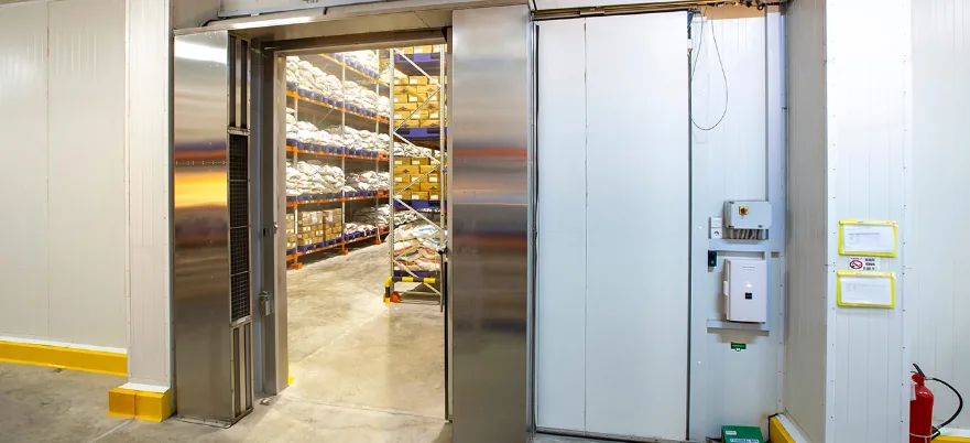 An open walk-in cold-storage room stocked with goods