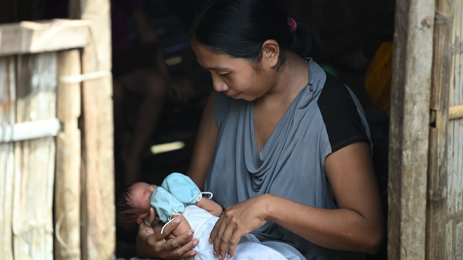 Sonia Agawin holding her newborn baby at home on Caponayan Island.