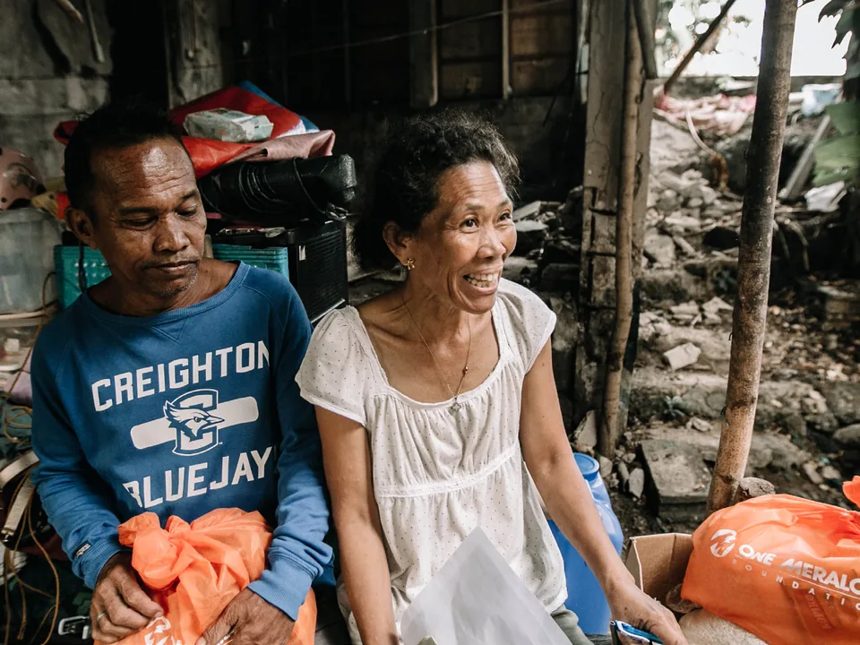 A Cebu couple beside relief packs delivered after the earthquake.