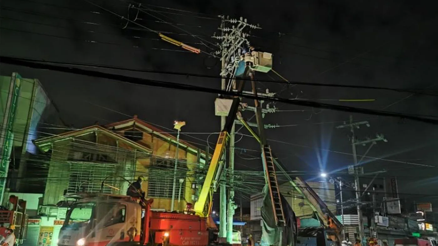 Meralco linemen working on pole relocation