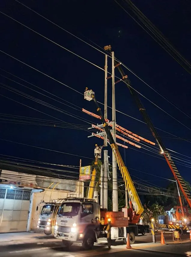 Meralco linemen working on power lines at night