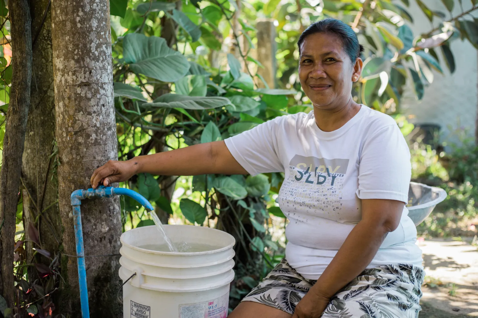 Resident Ma. Asuncion Fedelino of Sitio Central now collects water faster through communal watering points across the sitio.