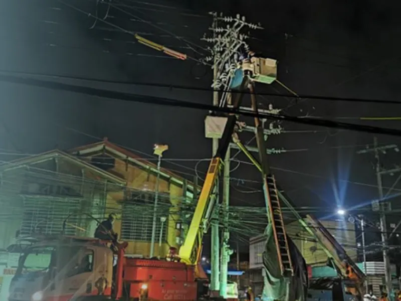 Meralco employees working on pole relocation