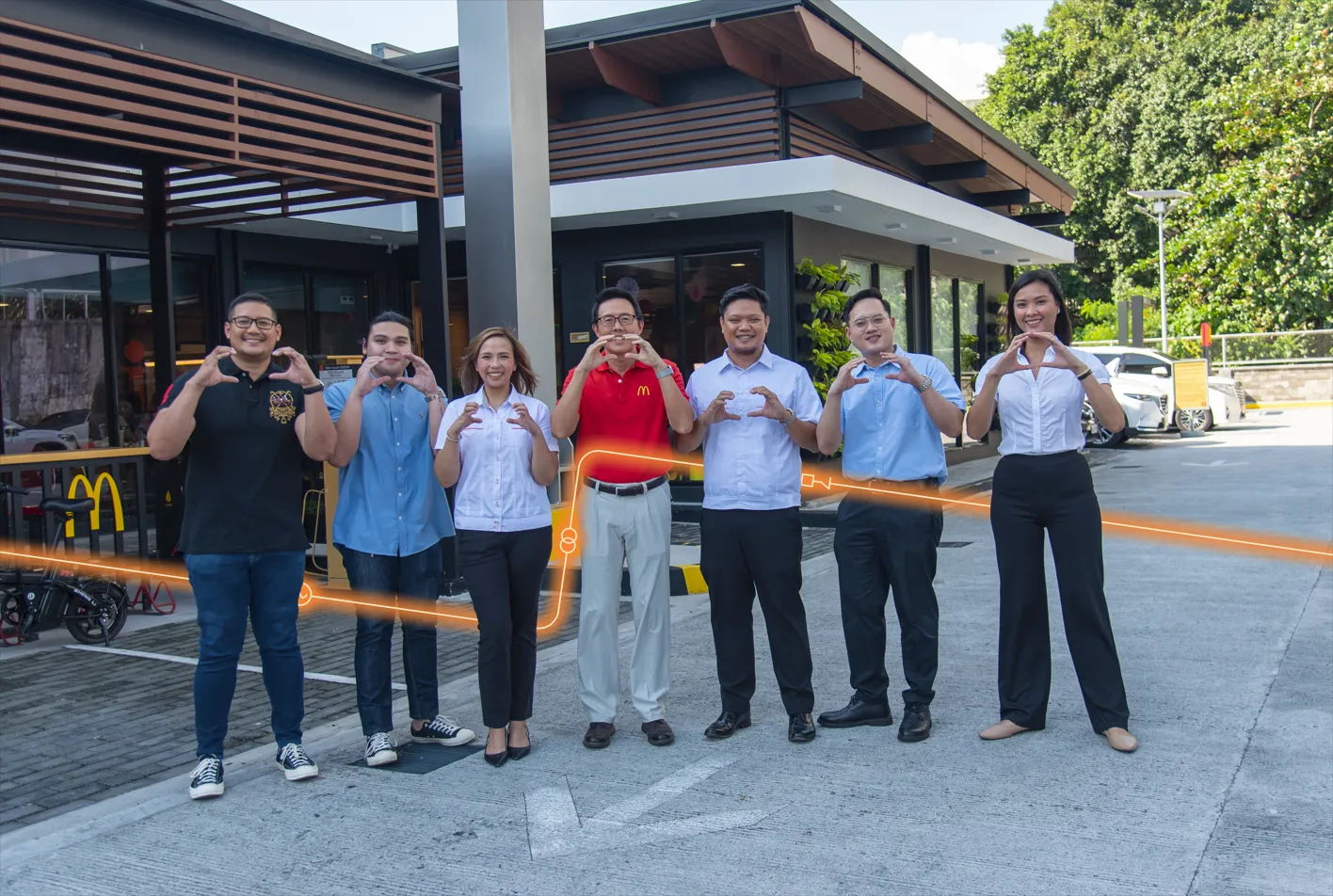 Meralco, MSpectrum, Movem, and McDonald’s Philippines representatives pose outside a Green and Good restaurant.