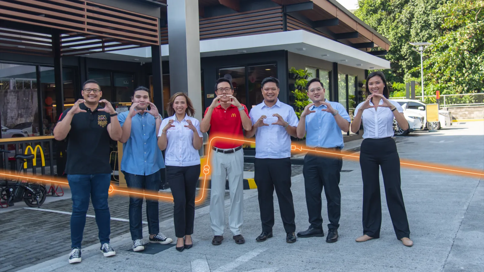 Meralco, MSpectrum, Movem, and McDonald’s Philippines representatives pose outside a Green and Good restaurant.