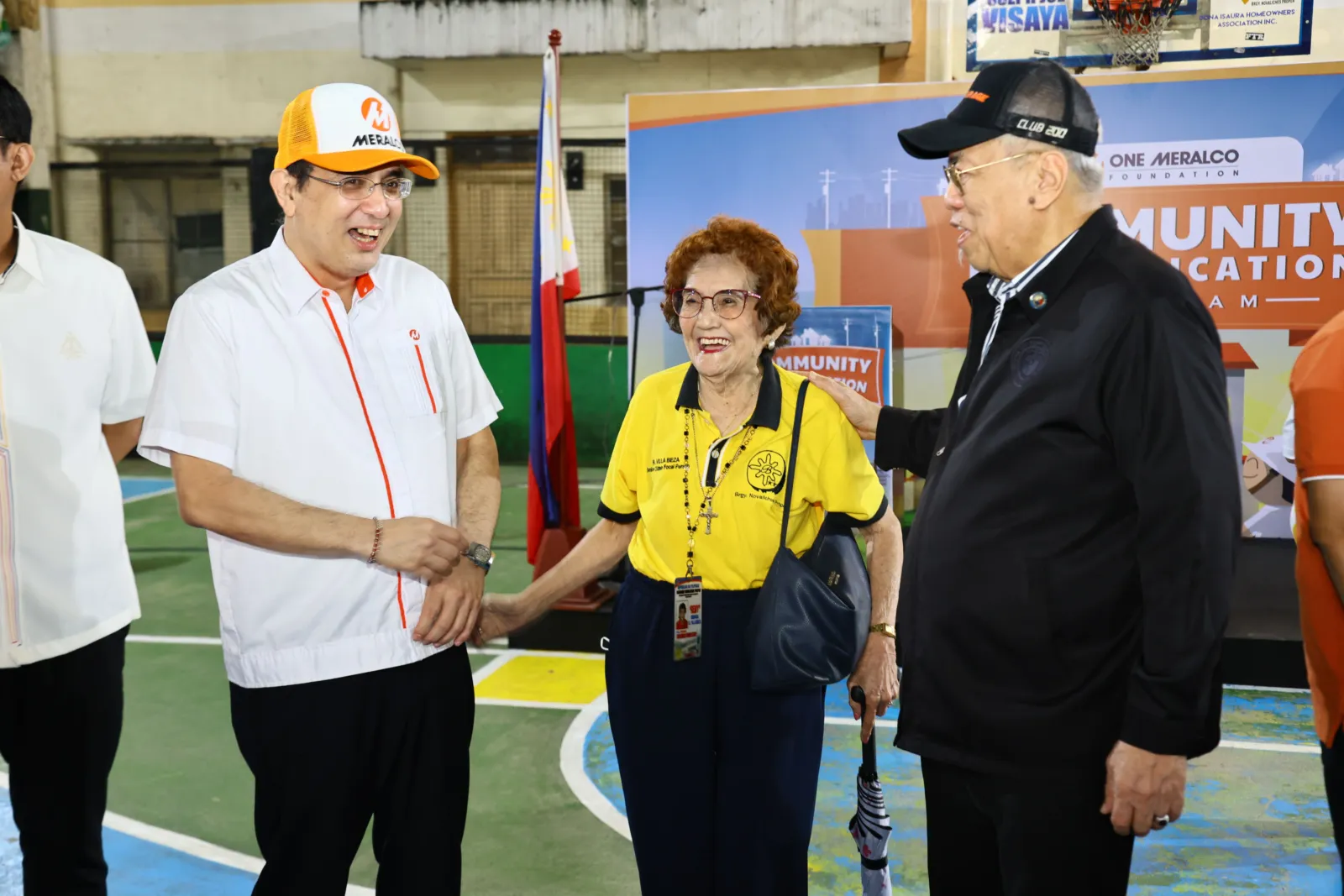 Joe R. Zaldarriaga and Rep. Rodolfo “Ompong” Ordanes greet a senior attendee at the Novaliches lighting ceremony.