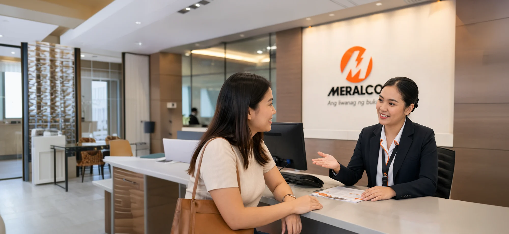 A customer speaking with a representative at a Meralco service counter