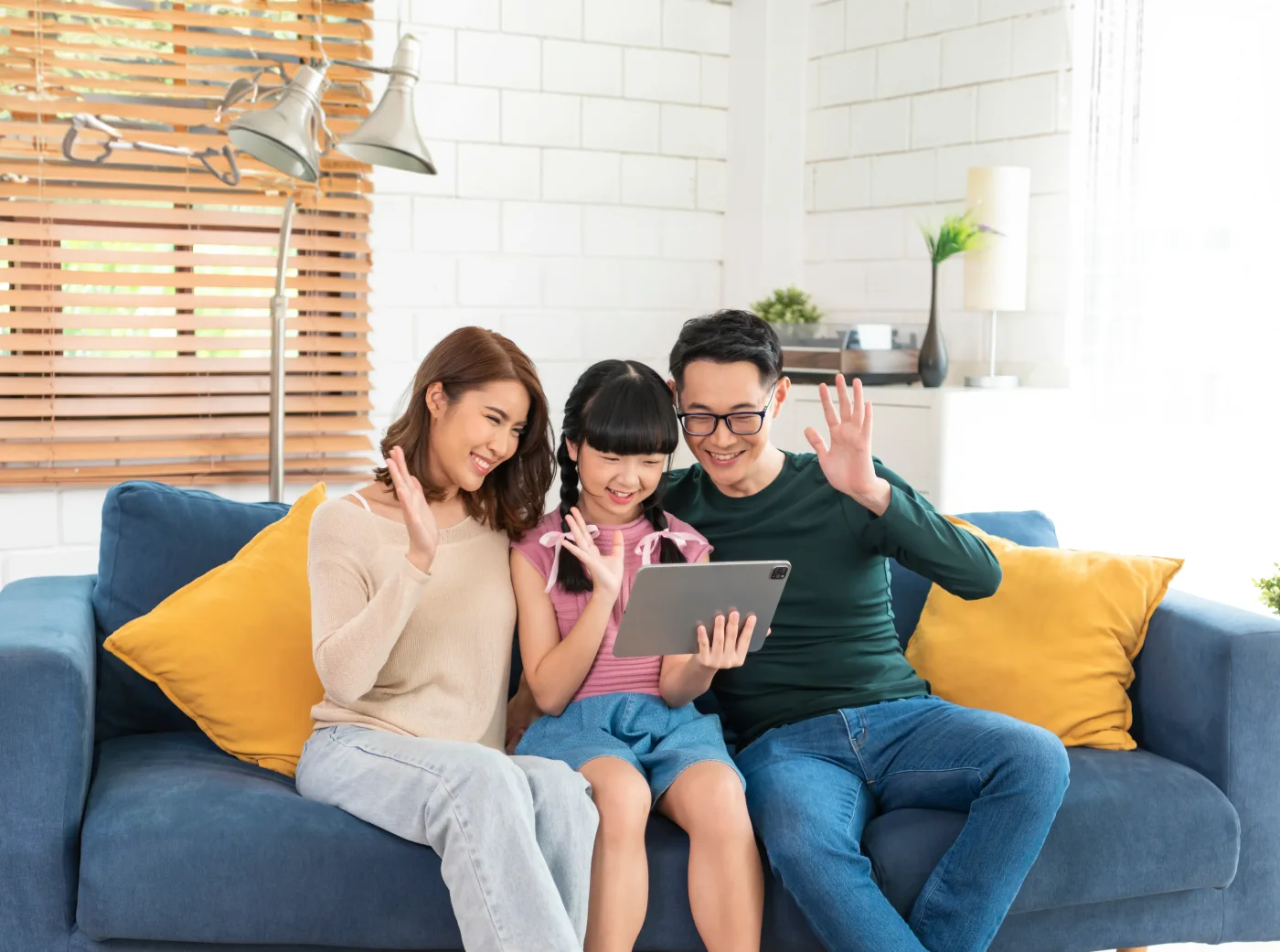 A family uses a tablet together at home.