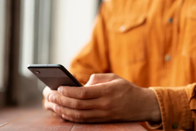 A customer uses a mobile phone to manage an account.