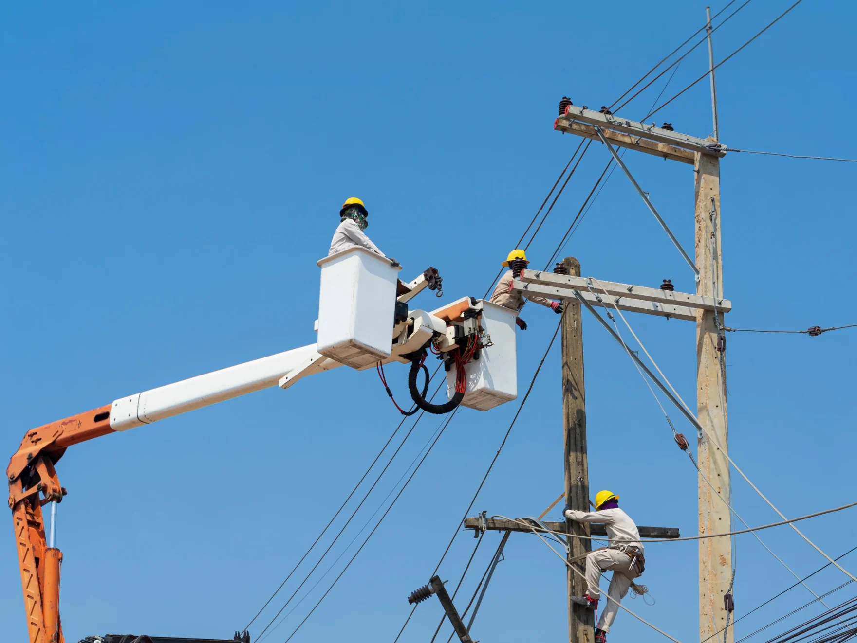 Meralco line workers inspect electrical equipment for a service request.